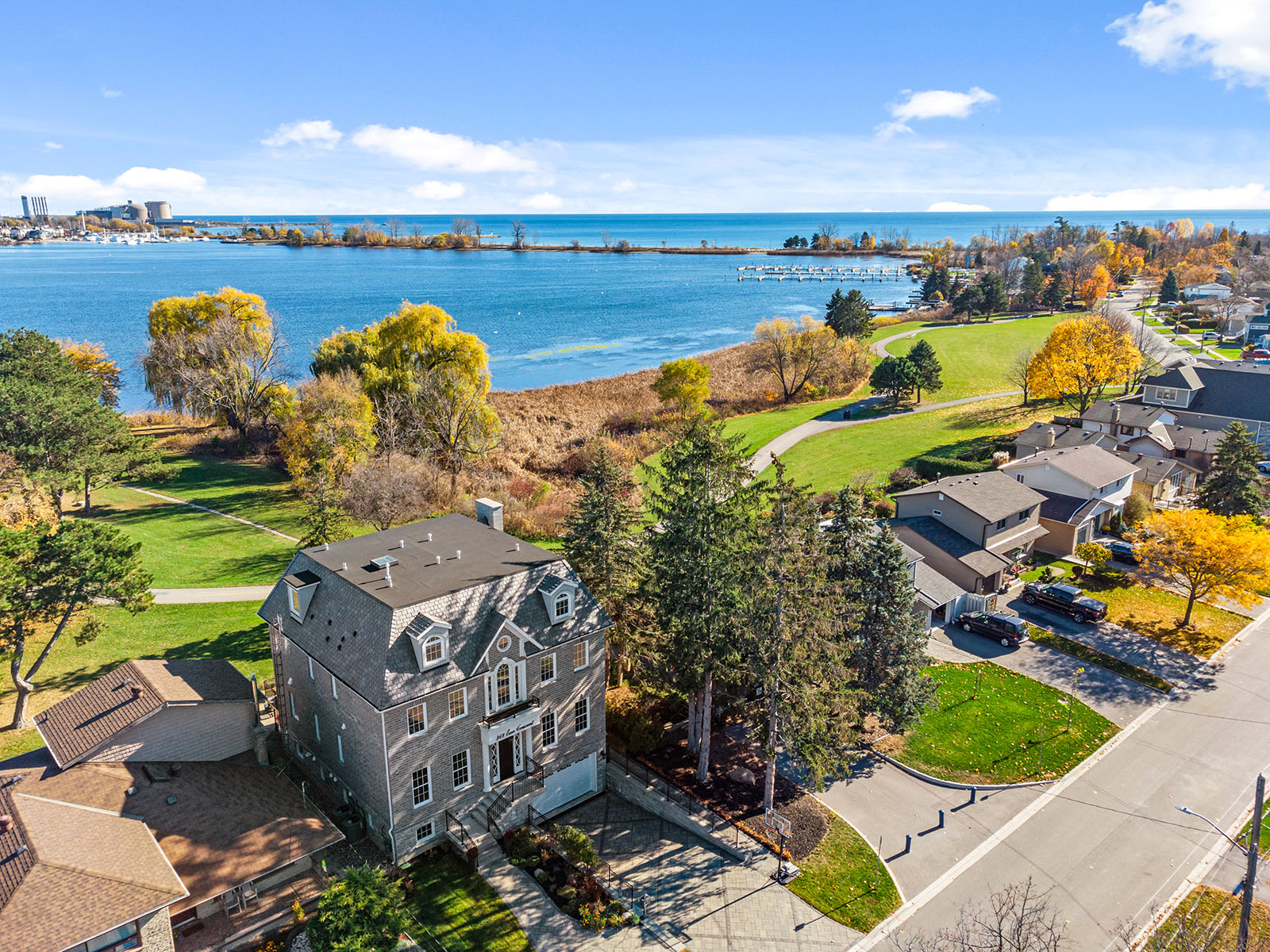 Professionally edited real estate drone photo of the front of a lakefront property.