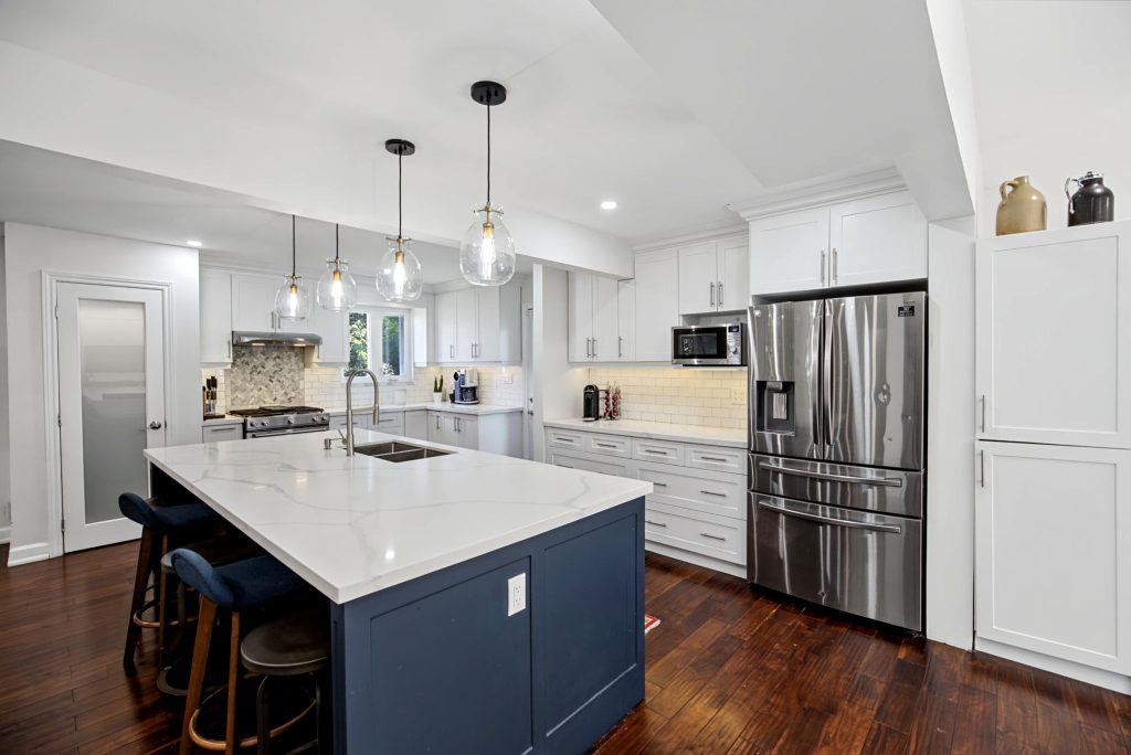 White kitchen with a blue island at 862 Boxworth Place in West Shore, Pickering
