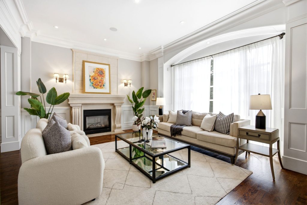 Living room with fireplace and large windows at 268 Brooke Avenue, Toronto